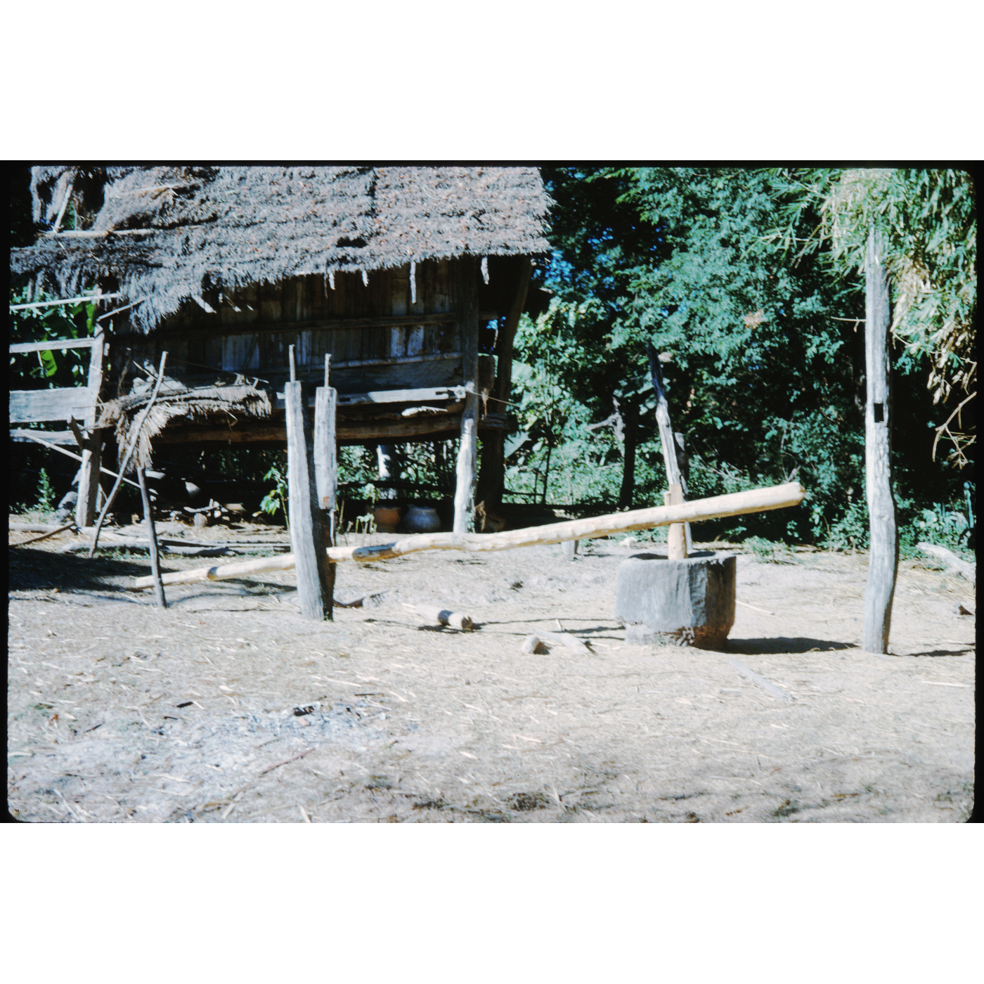 ครกกระเดื่อง (krok kradueang) — a Long Beam on Two Posts: Tread on Its End, and the Pestle Drops to Pound Rice in a Wooden Mortar