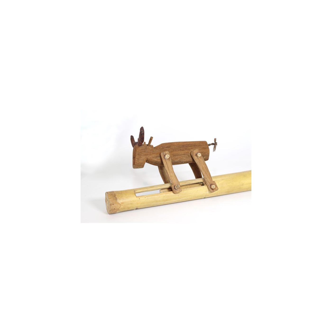 Sat Kradot (Jumping Animal, Sat Chak) — a Slotted Pai Ruak Bamboo Tube and a Pull Stick 8-10 cm Longer, the Front Legs Pinned to the Pull Stick and the Back Legs to the Tube; Pull In and Out and the Animal Runs and Leaps