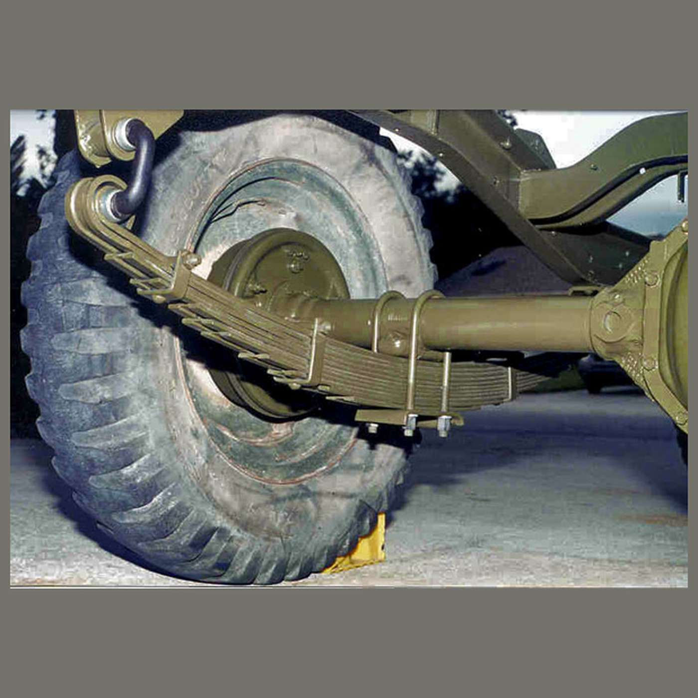 The Leaf Spring: A Beam That Carries the Load and Locates the Axle